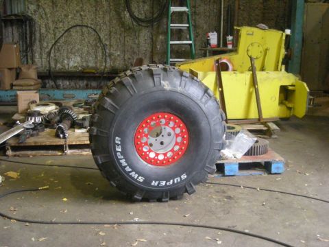 1979 Ford Bronco - A large off-road tire with 'Super Swamper' text is visible in a cluttered garage setting.