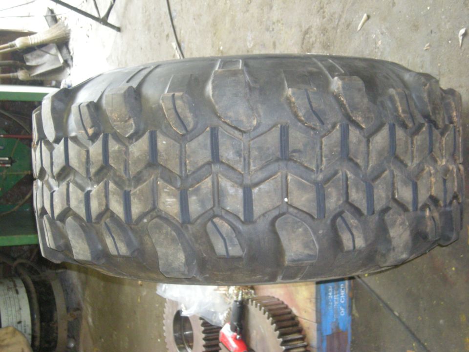 Close-up of a large off-road tire with a blocky tread pattern