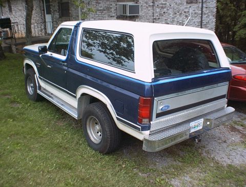1986 Ford Bronco - This 1986 Ford Bronco is seen in a rear 3/4 view, parked on grass.