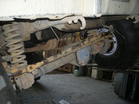 1979 Ford Bronco - Close-up of the undercarriage, focusing on the rear axle and suspension system.