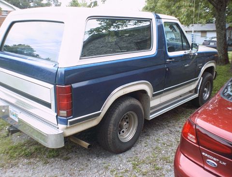 1986 Ford Bronco - This SUV has a two-tone paint scheme with a white top and blue lower body.