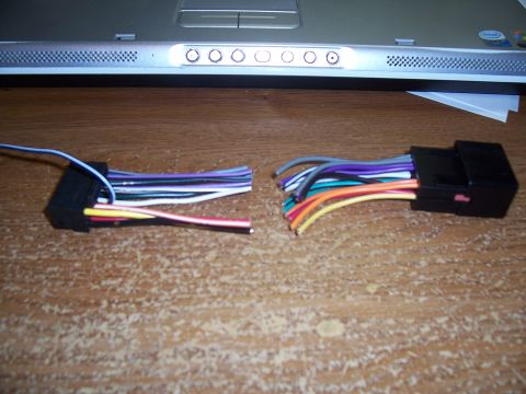 2003 Ford Ranger - Wiring harness adapters for car audio installation are laid out on a wooden surface.