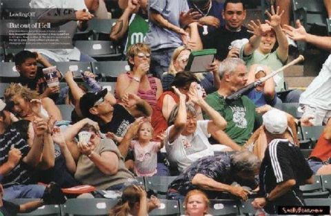2000 Mercury Grand Marquis - Spectators react in the stands during a sporting event, with one person holding a baseball bat.