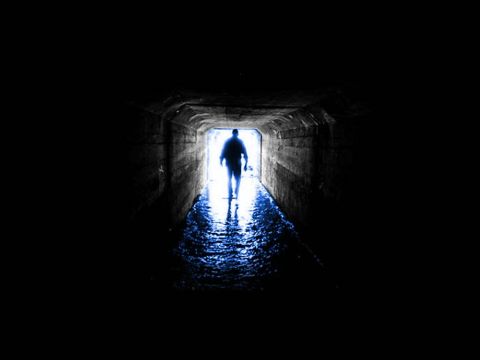 1990 Ford Bronco - A lone figure walks through a dark tunnel, illuminated by light at the far end.