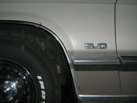 1988 Mercury Grand Marquis - A '5.0' emblem is visible on the fender of this car, near a tire with 'Indy' text.