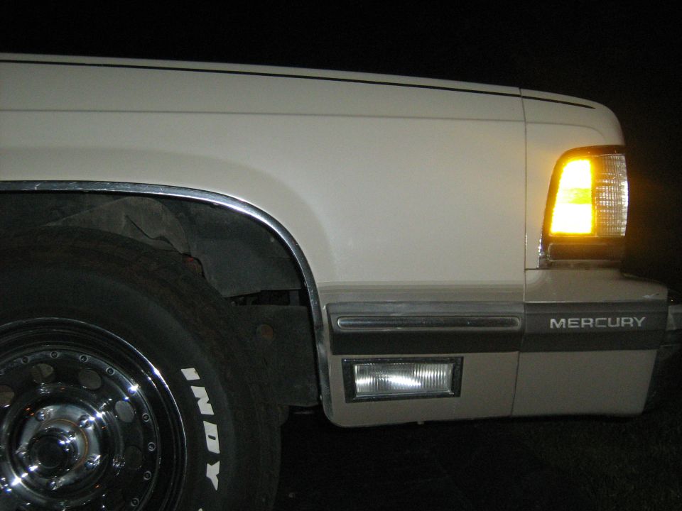 White 1988 Mercury Grand Marquis front corner with amber turn signal
