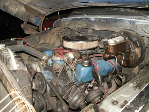 1977 Ford F-250 - The engine bay of a 1977 Ford F-250 shows its blue engine block, chrome air cleaner, and brake booster.