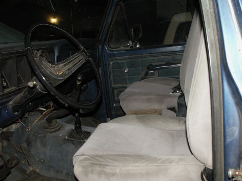 1977 Ford F-250 - Interior view of a 1977 Ford F-250 truck, highlighting the driver's side and passenger seat.
