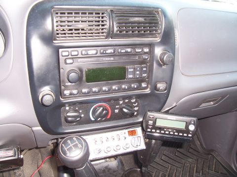 2003 Ford Ranger - The interior of a Ford Ranger pickup truck shows the center console with a CD player, climate controls, and two aftermarket radio units mou…