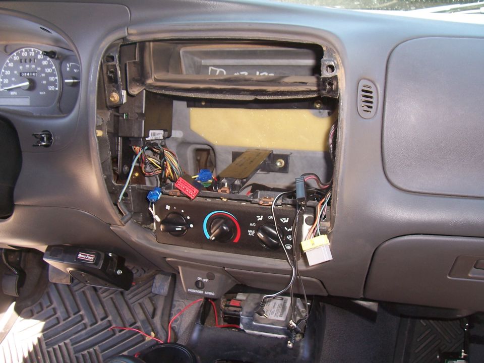Ford Ranger dashboard with center console disassembled, showing wiring, instrument cluster, and climate controls.