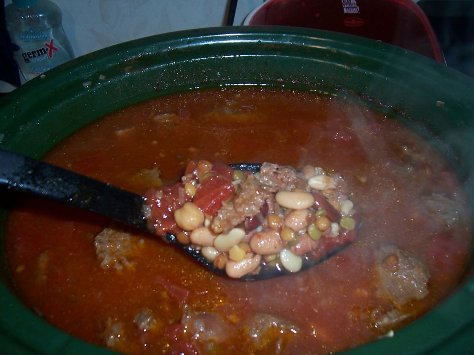 Photo of a spoonful of bean chili in a crock pot