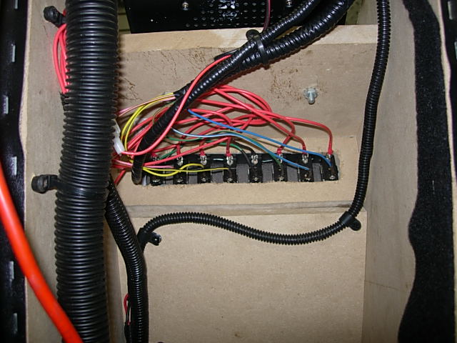 Electrical relays and wiring inside a vehicle.