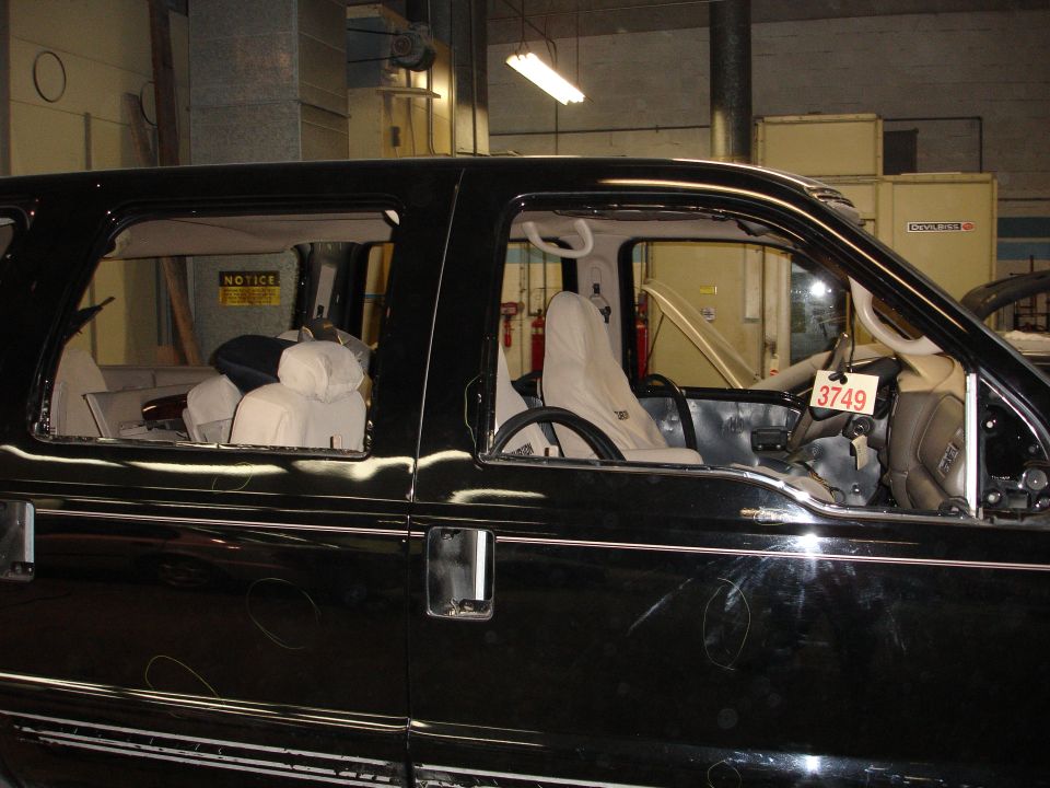 Black Ford Excursion interior and side view, doors removed, tag with "3749" on steering column.