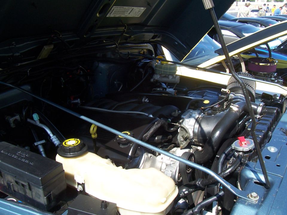 Photo of an engine bay with master cylinder and reservoir