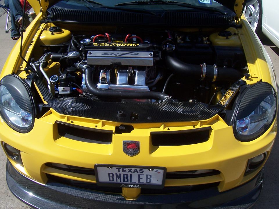 Photo of a turbocharged engine bay in a yellow Dodge Neon SRT-4