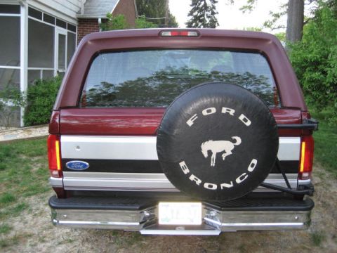 1996 Ford Bronco - The rear of a Ford Bronco, a spare tire cover with the iconic horse emblem.