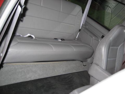 1996 Ford Bronco - Interior view of gray leather seats and carpet in a vehicle.