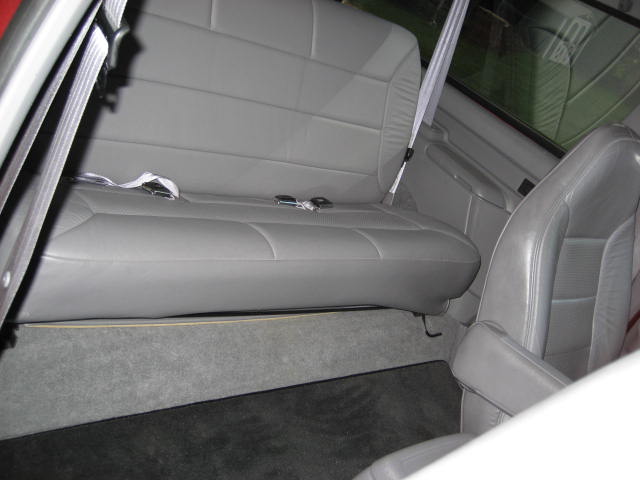 Gray leather seats and carpet inside a vehicle
