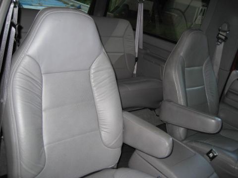 1996 Ford Bronco - Interior view of the gray leather front bucket seats and armrests in a 1996 Ford Bronco.