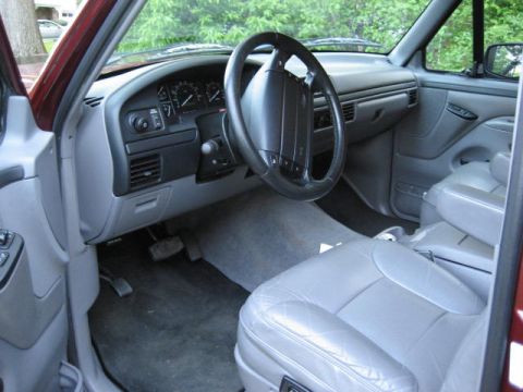 1996 Ford Bronco - The interior of a 1996 Ford Bronco features gray leather seats and a dark gray dashboard.