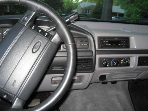 1996 Ford Bronco - The interior of a 1992 Ford truck shows the dashboard, steering wheel, and center console with radio and climate controls.