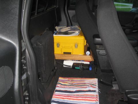2004 Ford Ranger - The interior of a truck cab is visible, with a yellow toolbox and other items stored behind the seats.