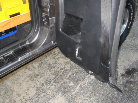 2004 Ford Ranger - The interior door panel of a vehicle shows some wear and tear, with a tire visible in the background.