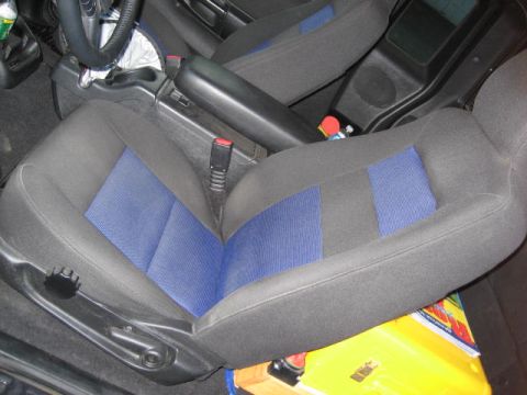 2004 Ford Ranger - The interior of a vehicle is shown, focusing on the driver and passenger seats with distinctive blue fabric accents.