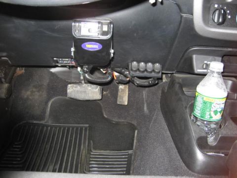 2004 Ford Ranger - Interior view showing a brake controller and four auxiliary switches mounted on the dashboard, with a bottle of Sprite in the cup holder.
