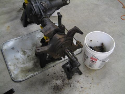 1996 Ford Bronco - A disassembled front axle assembly rests on jack stands, ready for repair or replacement.