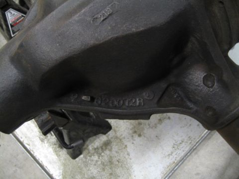 1996 Ford Bronco - A close-up view of a dark, cast iron automotive part with visible stamped identification numbers.