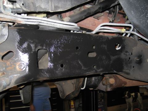 1996 Ford Bronco - Close-up view of a vehicle's undercarriage, showing the frame and various mechanical components.