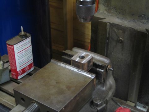 1996 Ford Bronco - A metal block is secured in a vise, ready for machining. A can of cutting fluid sits to the left.
