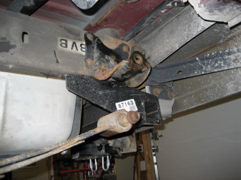 1996 Ford Bronco - Close-up view of the underside of a vehicle, showing the frame, fuel tank, and rear suspension components.