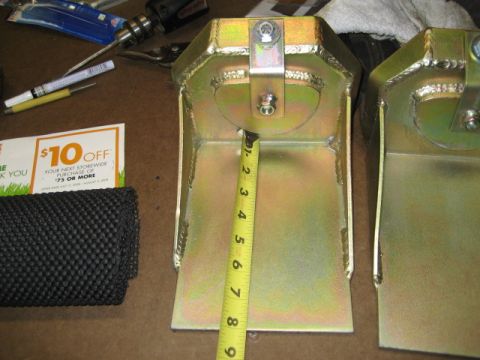 1996 Ford Bronco - A yellow metal part is measured with a tape measure, showing approximately 4 inches.