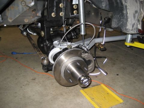 1996 Ford Bronco - The front suspension and brake system of a vehicle is shown in detail, with various mechanical components visible.