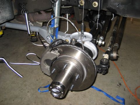 1996 Ford Bronco - Front suspension and brake assembly detail, showing the hub, rotor, and steering linkage.