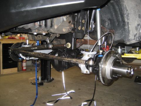1996 Ford Bronco - Close-up view of a vehicle's suspension and braking system, with parts laid out for inspection.
