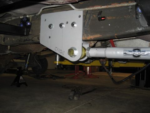 1996 Ford Bronco - Aftermarket suspension bracket and shock absorber installed on a vehicle frame.