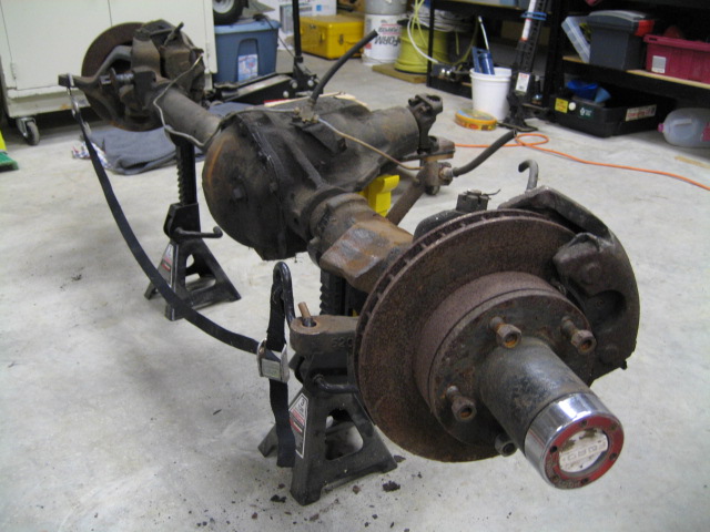 Front axle assembly on jack stands, showing disc brake and hub