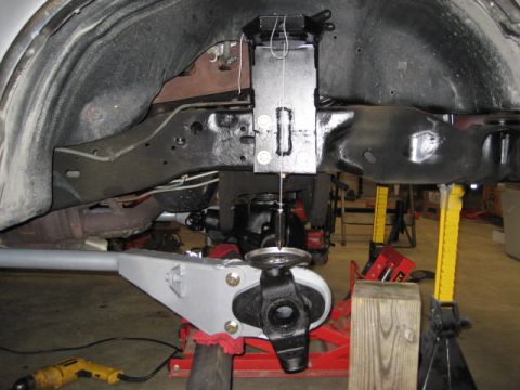 1996 Ford Bronco - Vehicle suspension components are shown with a plumb bob for alignment measurements.
