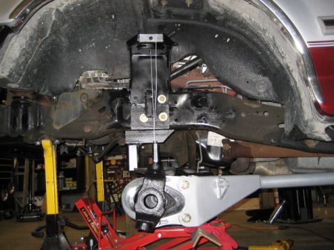 1996 Ford Bronco - Vehicle is on jack stands with suspension components being worked on. A lift kit is being installed.