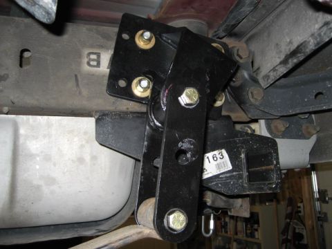 1996 Ford Bronco - Close-up view of a black metal suspension component installed on a vehicle's undercarriage.