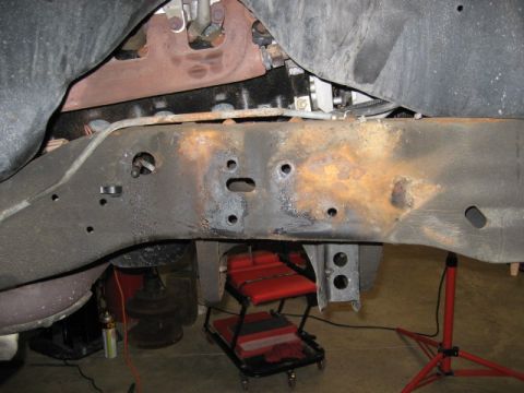 1996 Ford Bronco - Underside view of a vehicle's frame and engine components, showing signs of wear and rust.