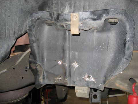 1996 Ford Bronco - Inner fender liner shows signs of wear and tear, with visible rust spots and impact marks.