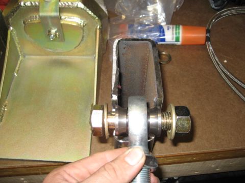 1996 Ford Bronco - A close-up view of a metal suspension part, likely for off-road modification, held by a hand.