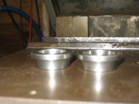 1996 Ford Bronco - Two machined metal rings sit on a metallic surface, with workshop equipment in the background.