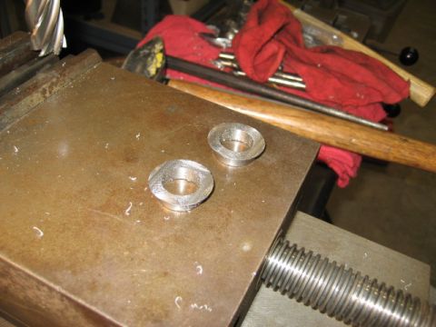 1996 Ford Bronco - Machined bushings on a vise, likely in a workshop setting.