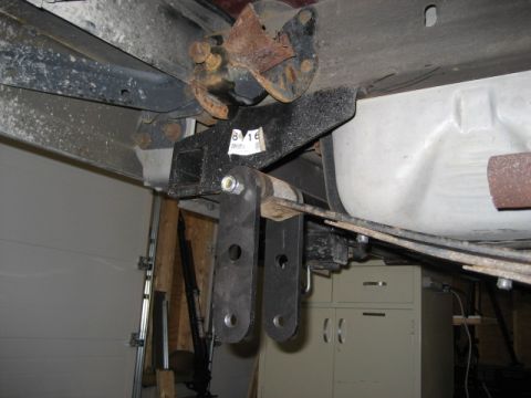 1996 Ford Bronco - Underside view of a vehicle's rear suspension system, showing a trailer hitch and leaf springs.