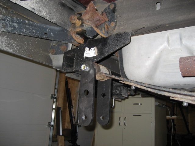 close-up of rear suspension parts, including a hitch receiver and leaf springs